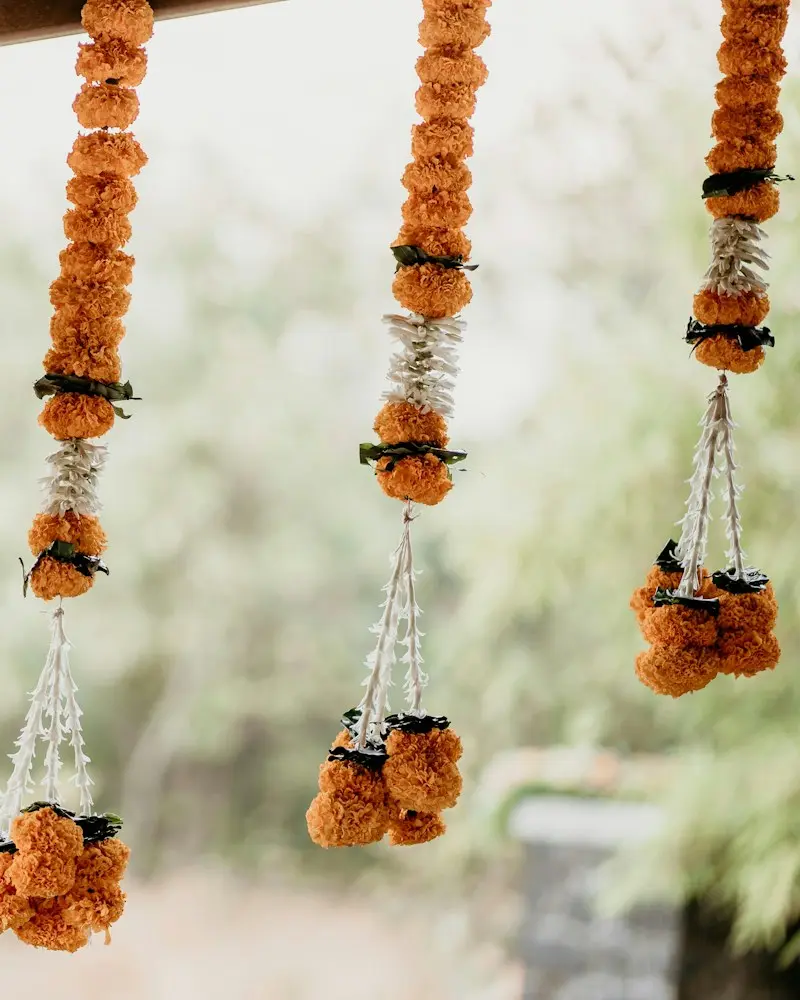 Marigold and jasmine garlands hanging in a row
