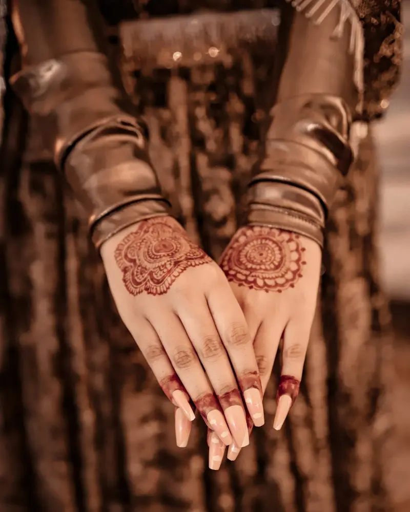 Hands with fine henna patterns held together